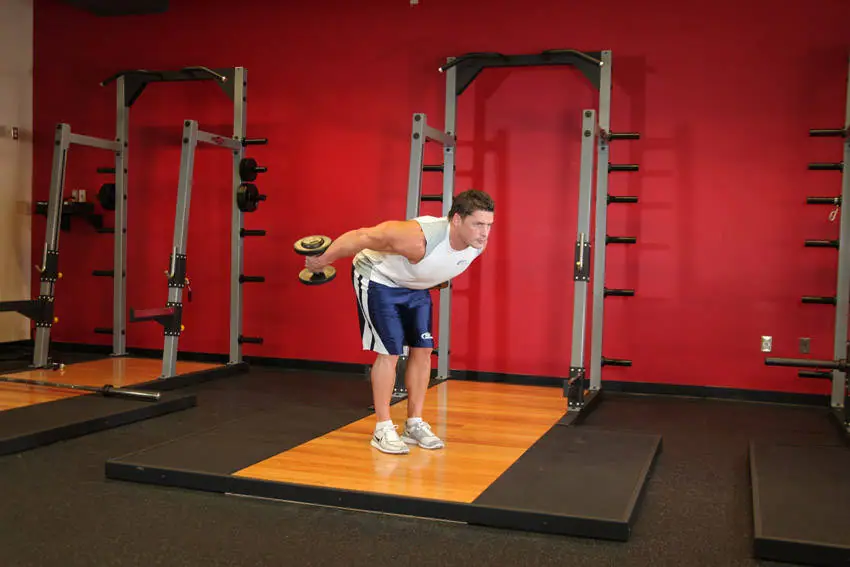 Standing Bent-Over Two-Arm Dumbbell Triceps Extension — posisi akhir